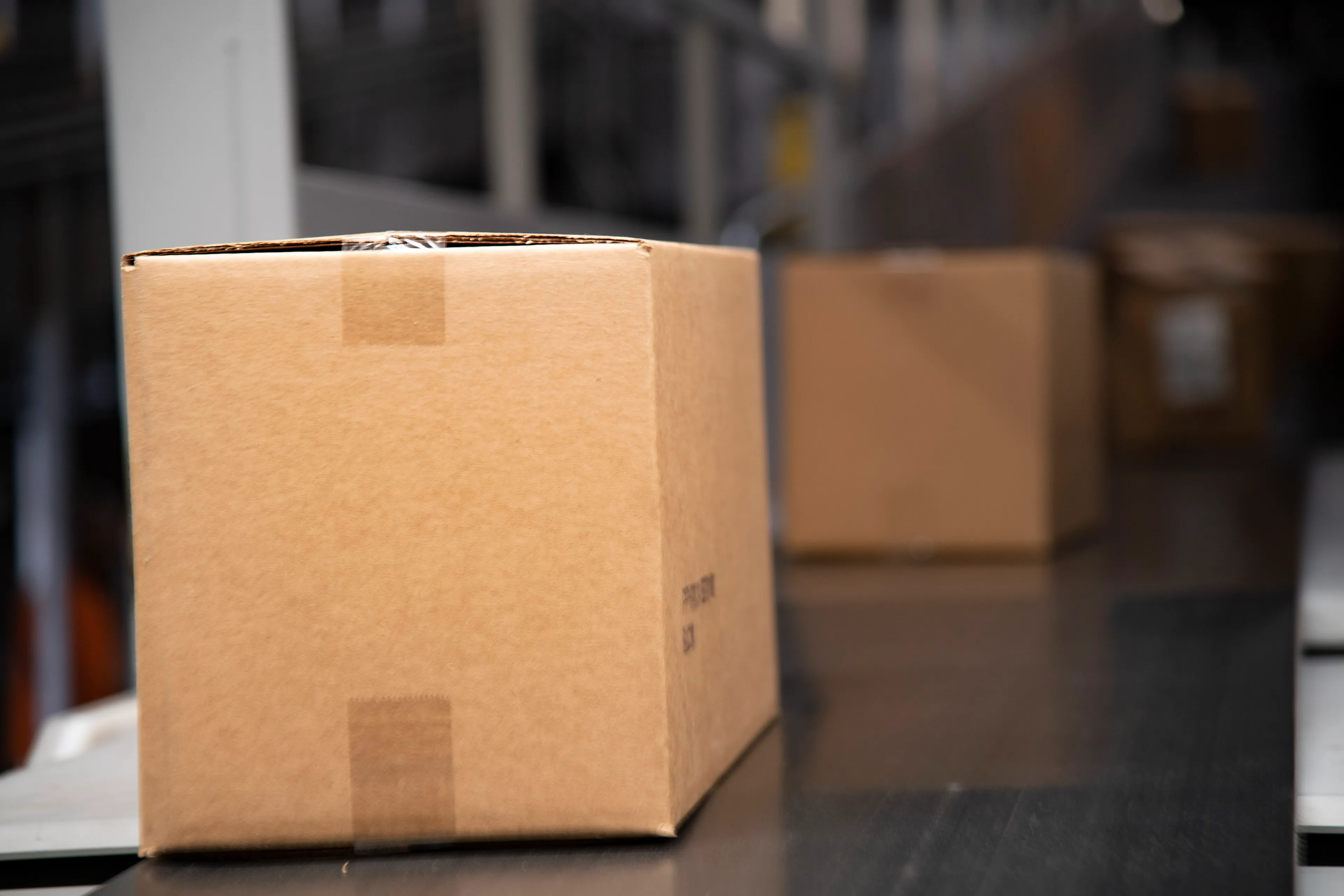 A cardboard parcel moving along a conveyor belt