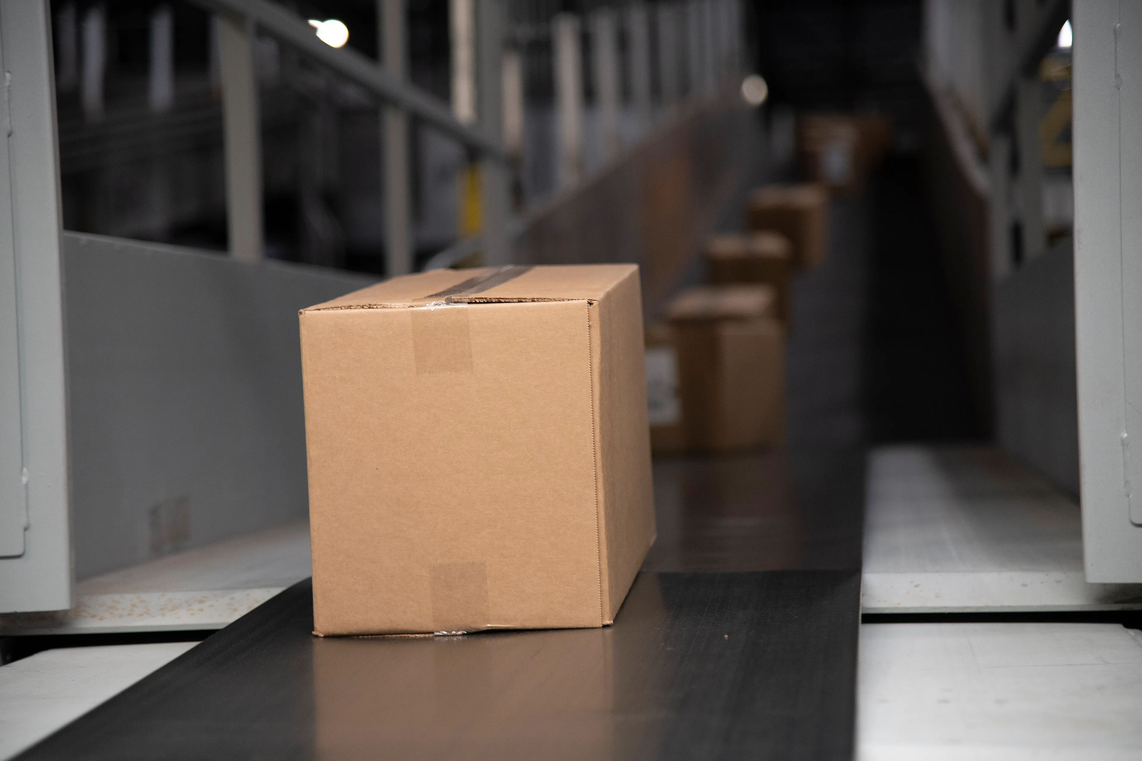 Parcels travelling along a conveyor belt inside a sorting facility